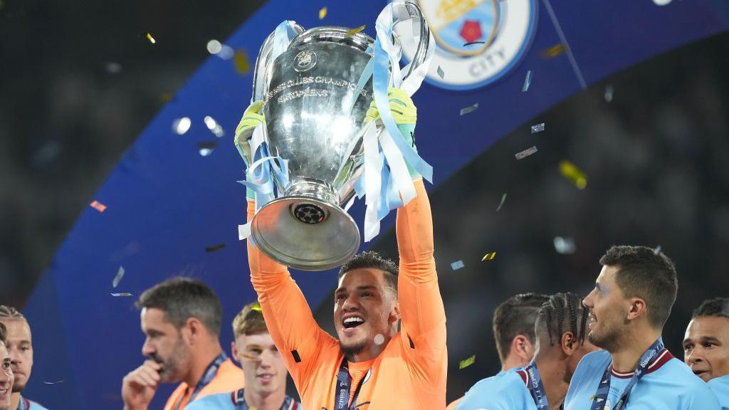 Ederson lifts the Champions League trophy